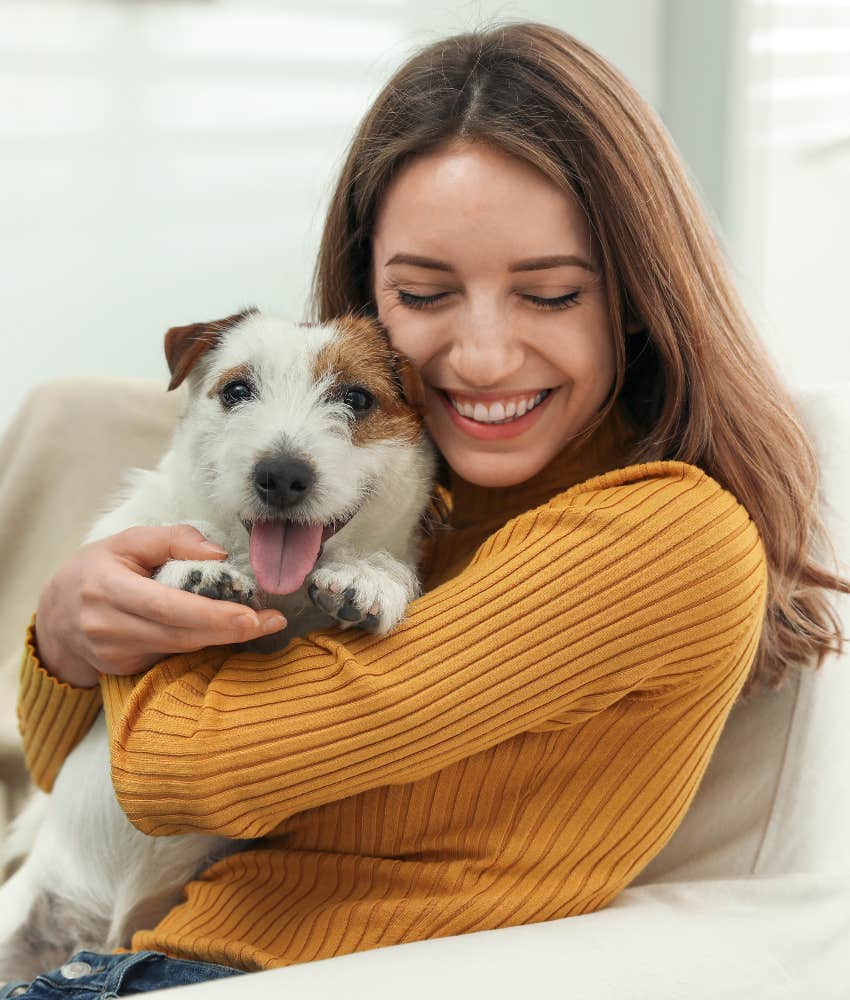 woman hugging small dog living stress-free life