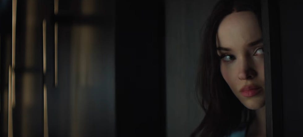 dove cameron as ciara hiding behind a wall with her face partially showing in prime videos 56 days