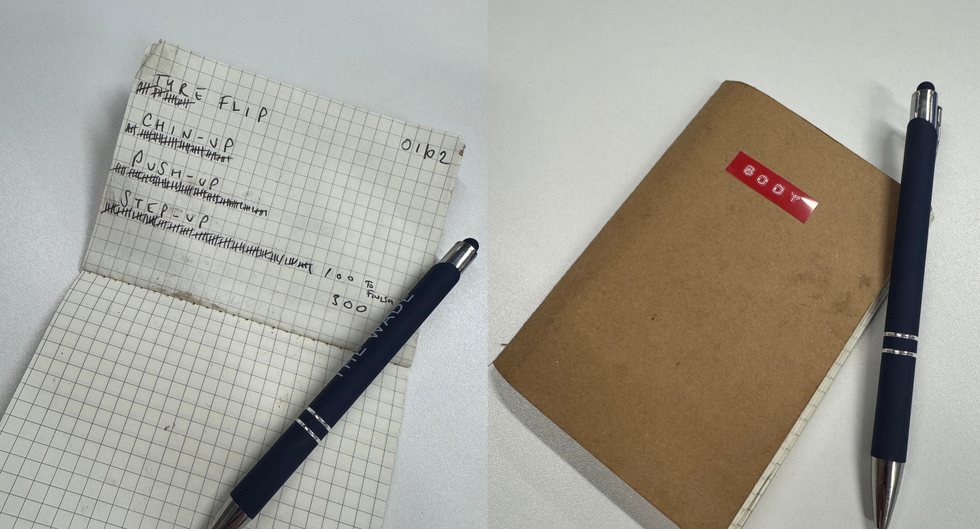 notepad with workout exercises listed and a pen