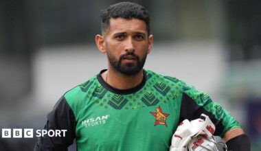 Zimbabwe's Sikandar Raza carries his batting gloves and his helmet under his arm during a practice session