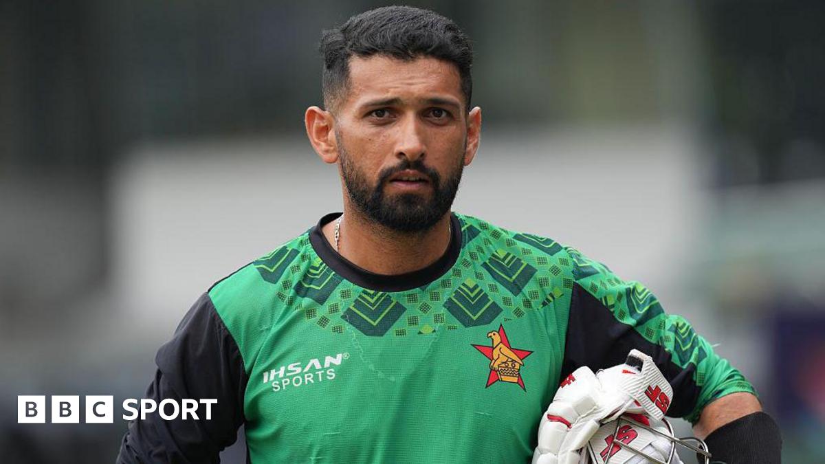 Zimbabwe's Sikandar Raza carries his batting gloves and his helmet under his arm during a practice session