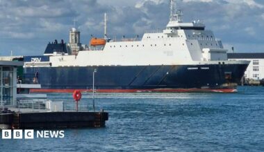 The dark blue and white Caesarea Trader in Portsmouth Harbour