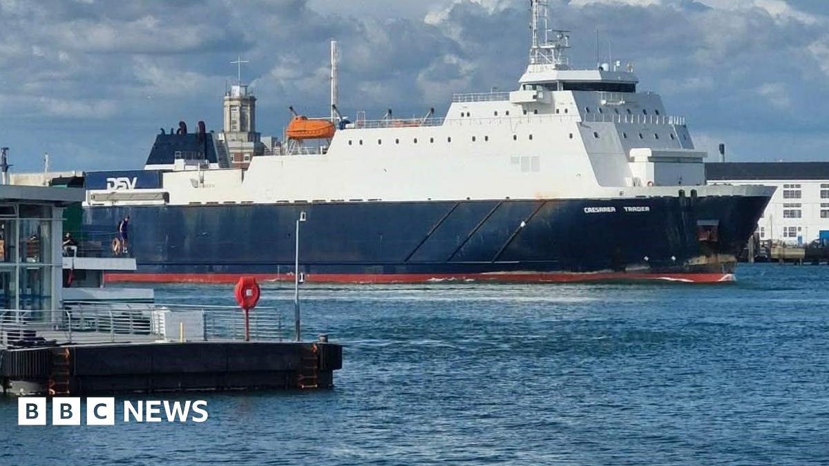 The dark blue and white Caesarea Trader in Portsmouth Harbour