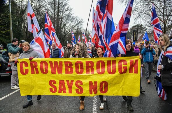 Protesters march holding Crowborough says no sign