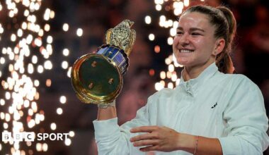 Karolina Muchova holds the Qatar Open trophy aloft