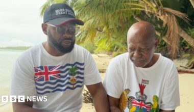 Misley Mandarin and another Chagossian man standing on the beach of a remote part of the Chagos Islands
