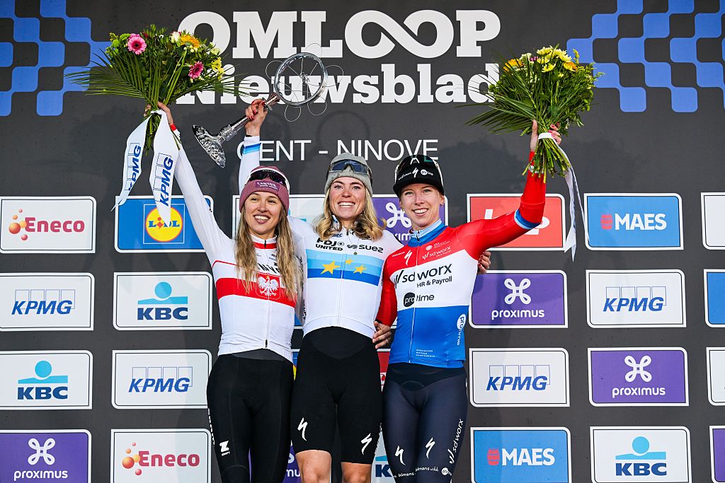 Polish Katarzyna Niewiadoma-Phinney of CANYON//SRAM Zondacrypto, Dutch Demi Vollering of FDJ United-SUEZ and Dutch Lorena Wiebes of SD Worx-Protime pictured on the podium after the women's one-day cycling race Omloop Het Nieuwsblad (UCI World Tour), the opening race of the Flemish one-day classics season, 137,6 km from Gent to Ninove, Saturday 28 February 2026. BELGA PHOTO DAVID PINTENS (Photo by DAVID PINTENS / BELGA MAG / Belga via AFP)
