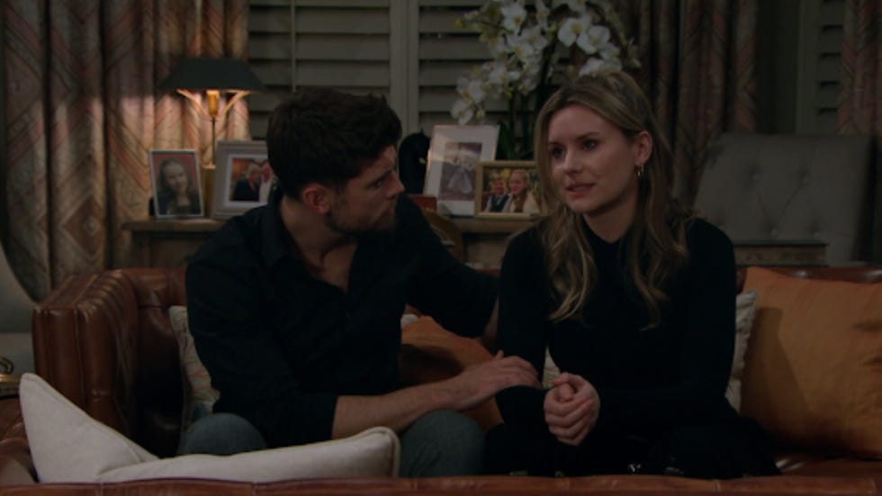 a couple sitting on a couch in a cozy living room