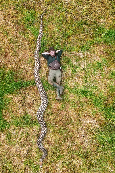 explorer-and-nature-photographer-radu-frentiu-beside-reticulated-python-ibu-baron-in-sulawesi