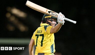Alyssa Healy raises her bat after reaching 50 against India in the first ODI in Brisbane
