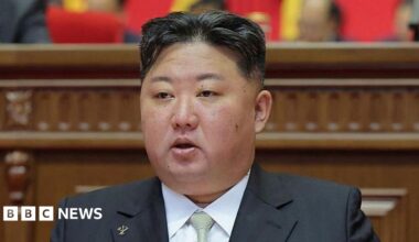 Kim Jong Un wearing a black suit and light green tie