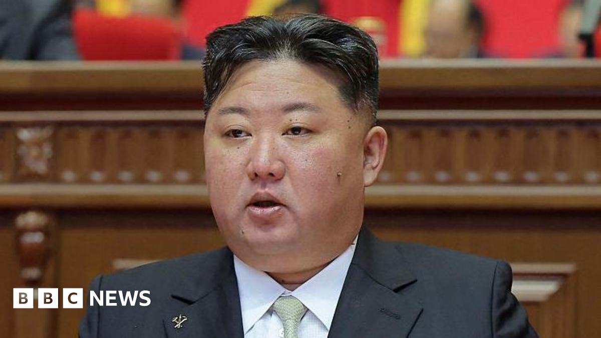 Kim Jong Un wearing a black suit and light green tie
