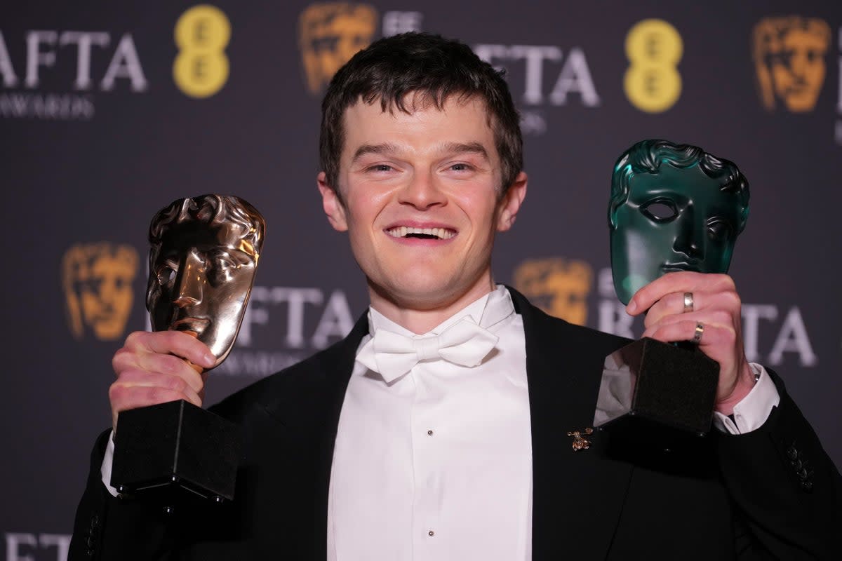 Robert Aramayo poses with his two Bafta awards (AP)