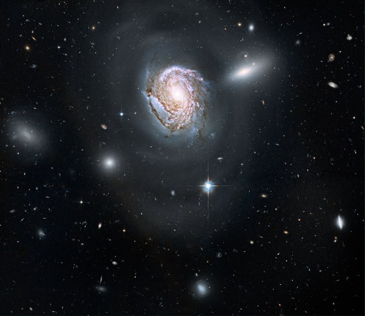 A spiral-shaped galaxy with a bright spot in the center