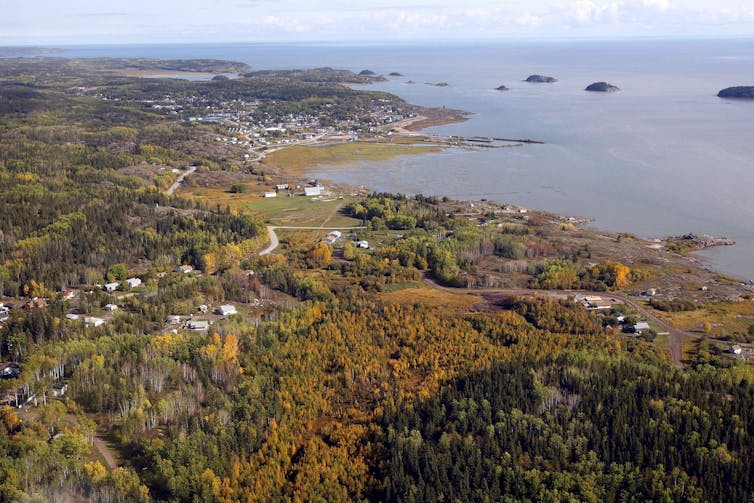 An aerial view of a small town near the shore of a lake