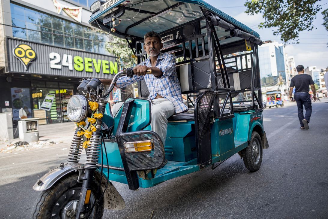 An e-rickshaw driver travels along a street in New Delhi, India, on September 22, 2018.