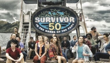 The cast of Survivor season 50 gathered under a sign that says 'Survivor 50 In the Hands of the Fans'.