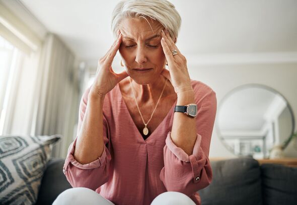 Headache pain, anxiety and senior woman thinking of mental health problem on the living room sofa in house. Sad elderly person with depression, home s