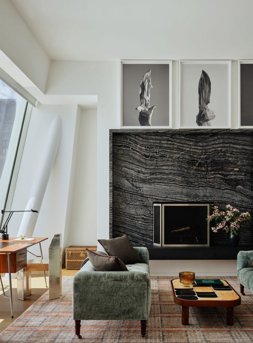Study with vintage and contemporary furniture, plus an oversized dark stone fireplace