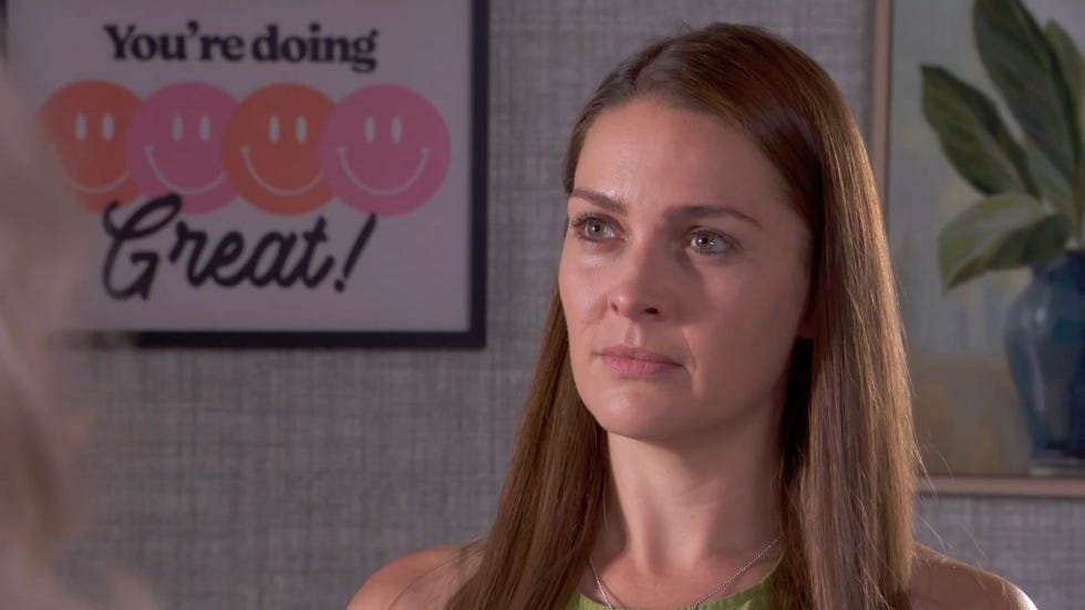 Hollyoaks, Sienna Blake hollyoaks, sienna blake in the living room, with a poster of smiley faces and you're doing great text on it