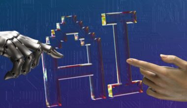 AI letters with robot and human fingers touching the AI lettering