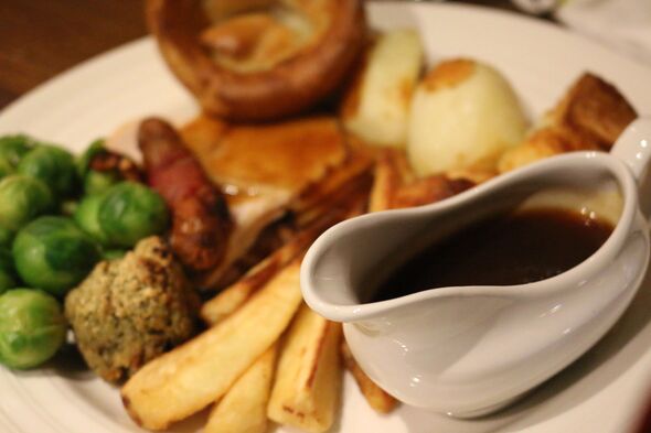 Image of gravyboat with roasted beef Sunday dinner, Yorkshire puddings