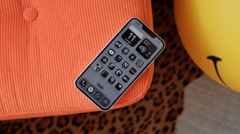 iphone 16e home screen on chair