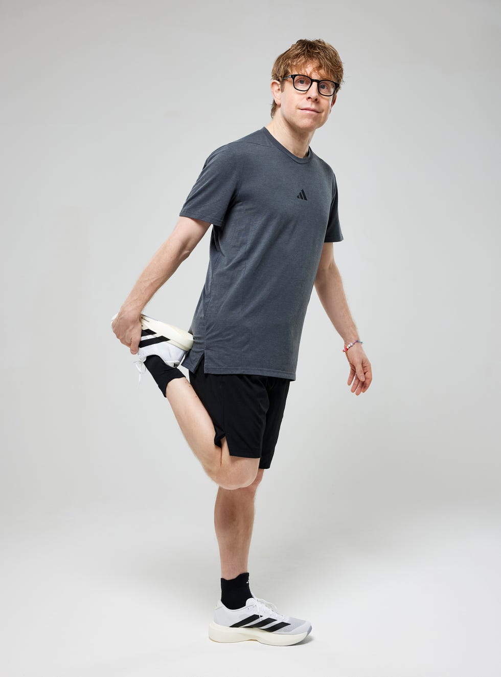 Josh Widdicombe person stretching leg in athletic wear