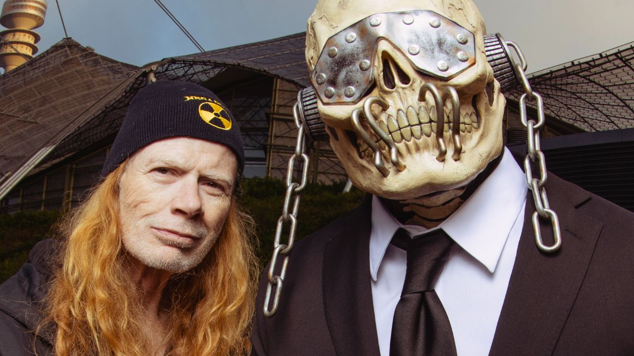 Megadeth singer/guitarist Dave Mustaine standing next to the band's skeleton mascot Vic Rattlehead
