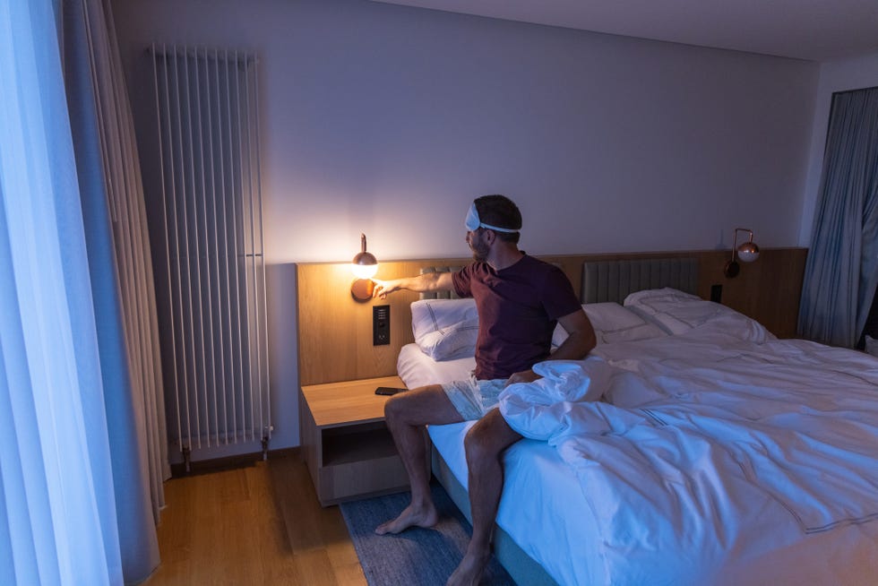 man getting ready for sleep, he wears an eye mask