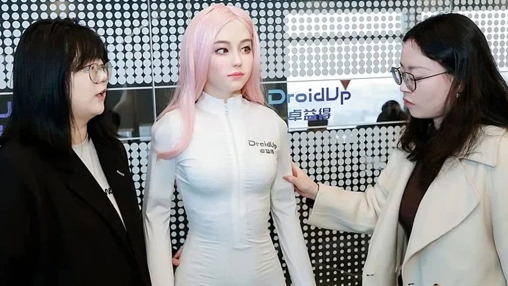 A photo of two technicians next to Moya.