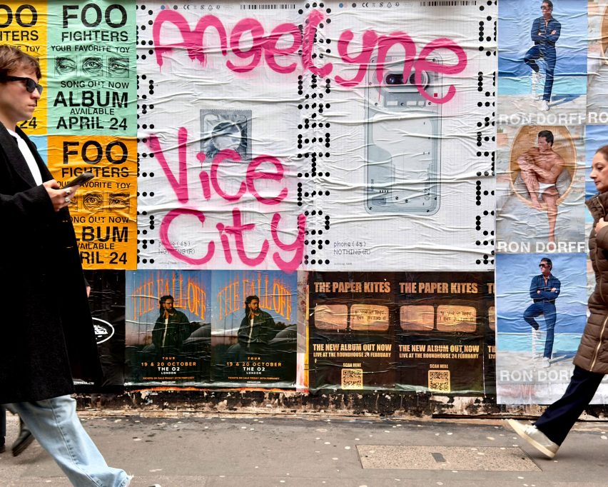 Photo of a Nothing poster on a street wall grafittied in hot pink with the words Angelyne and Vice City
