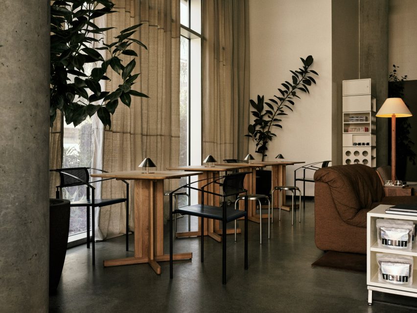 Row of wooden two-top tables beside tall curtains