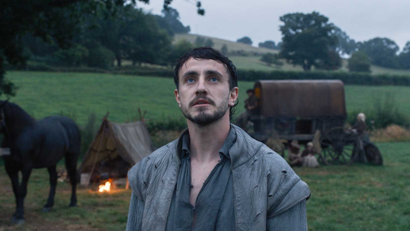 Paul Mescal as the husband staring up at something while outdoors in Hamnet