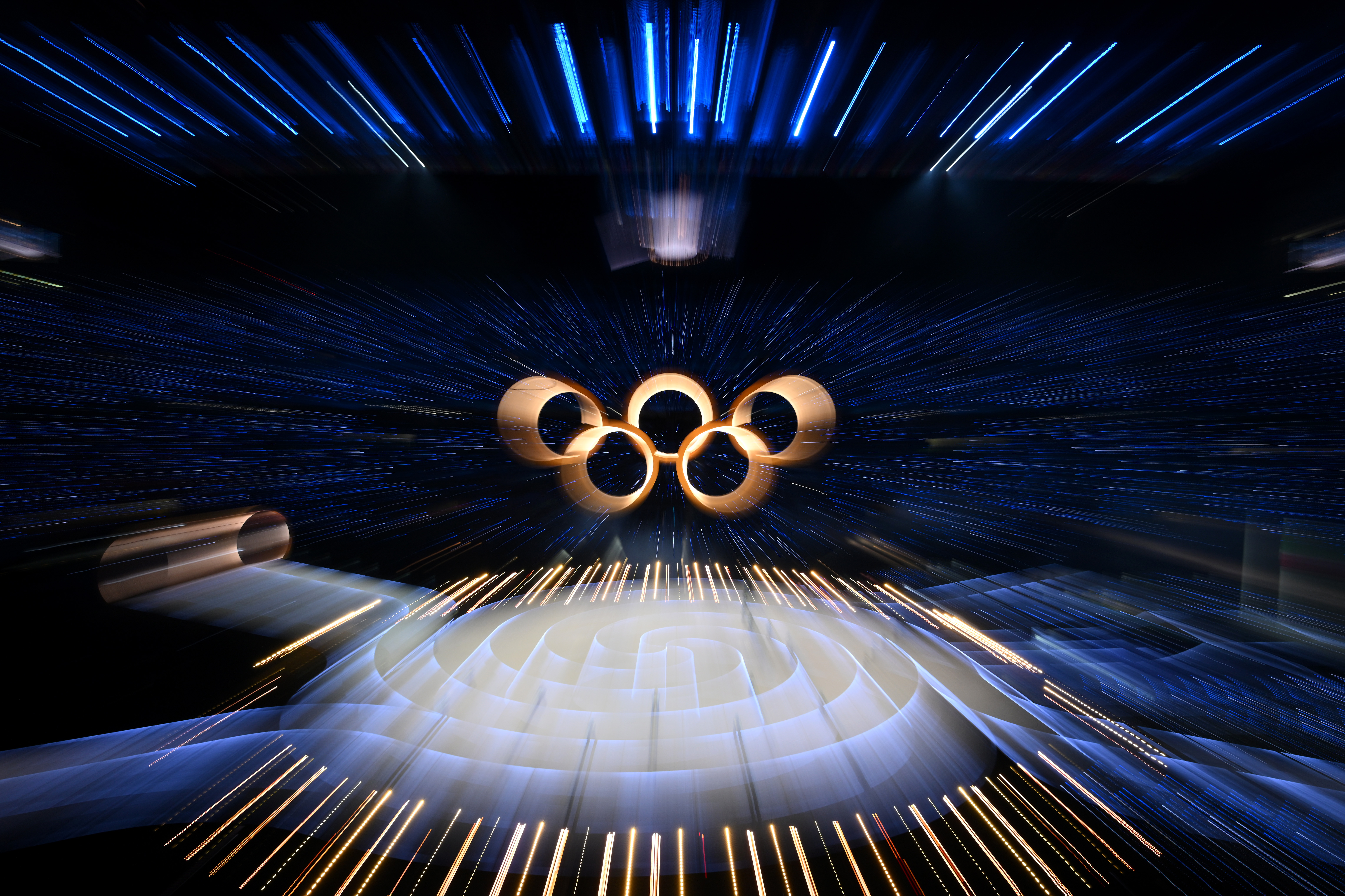 MILAN, ITALY - FEBRUARY 06: The rings come together to form the Olympic logo during the opening ceremony of the Milano Cortina 2026 Winter Olympics at San Siro Stadium on February 06, 2026 in Milan, Italy. (Photo by Matthias Hangst/Getty Images)