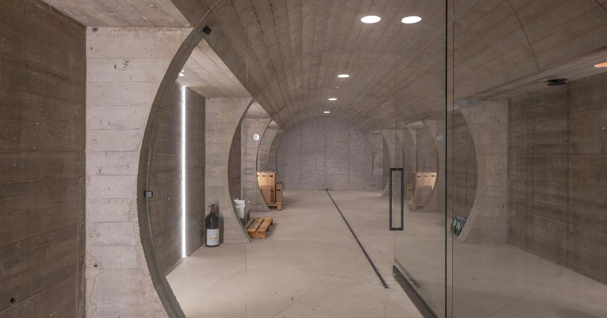 barrel-vaulted concrete cellar organizes vineyard building in poland