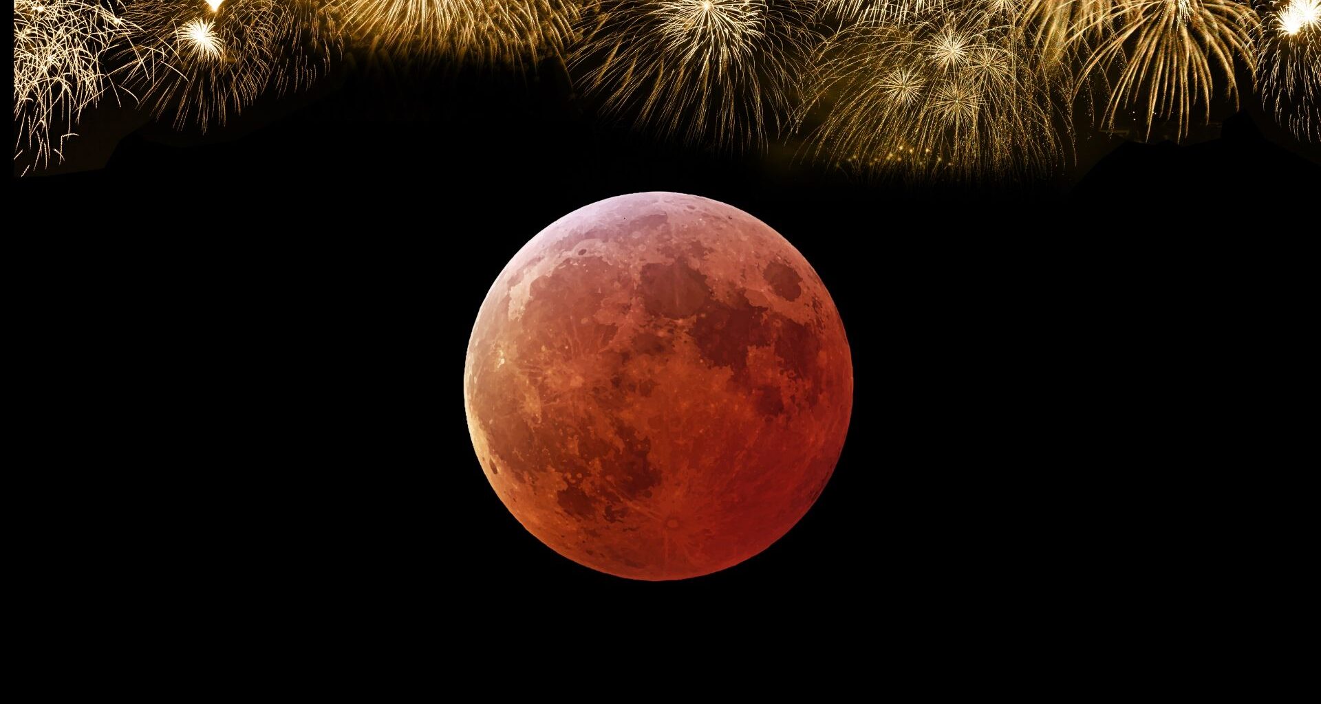 close up view of a blood red moon during total lunar eclipse and above is golden fireworks symbolizing new year's eve.