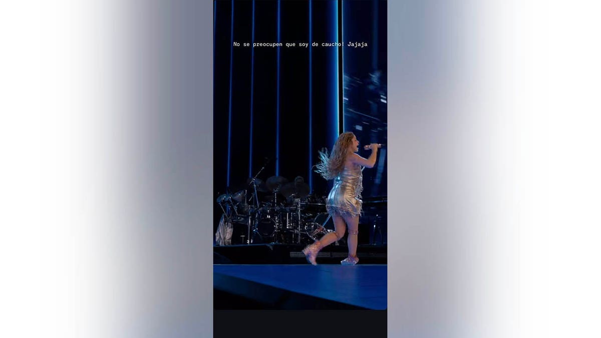 Shakira getting up from falling on stage