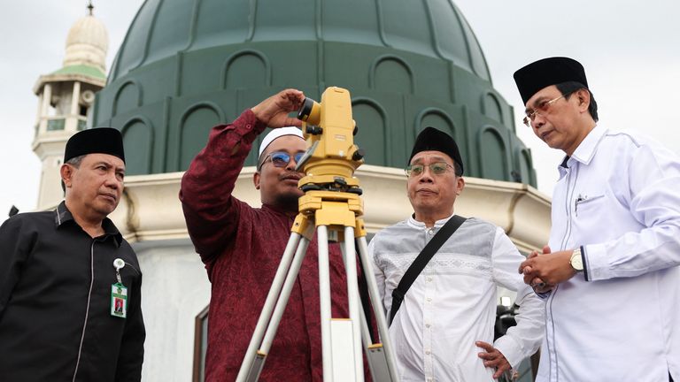 Men on the roof of the Al-Musyari'in mosque in Jakarta. Pic: Reuters