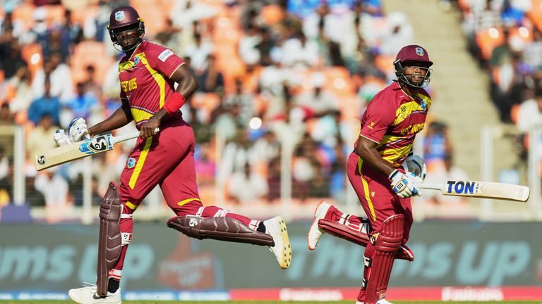 West Indies' Jason Holder, left, and batting partner Romario Shepherd run between the wickets during the T20 World Cup cricket match between South Africa and West Indies in Ahmedabad, India, Thursday, Feb. 26, 2026. (AP Photo/Ajit Solanki)