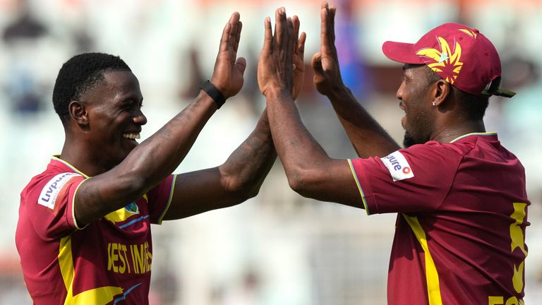 West Indies' Shamar Joseph, left, and West Indies' Matthew Forde celebrate the wicket against Italy