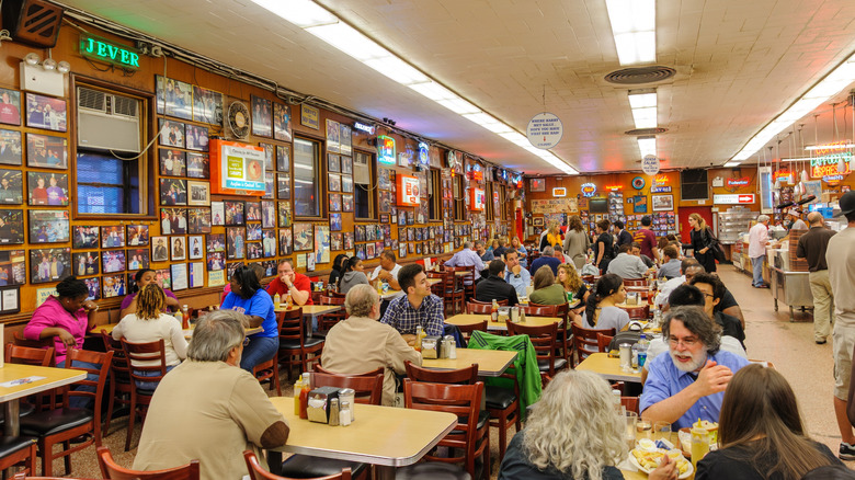 Customers sitting at tables inside Katz' Jewish deli