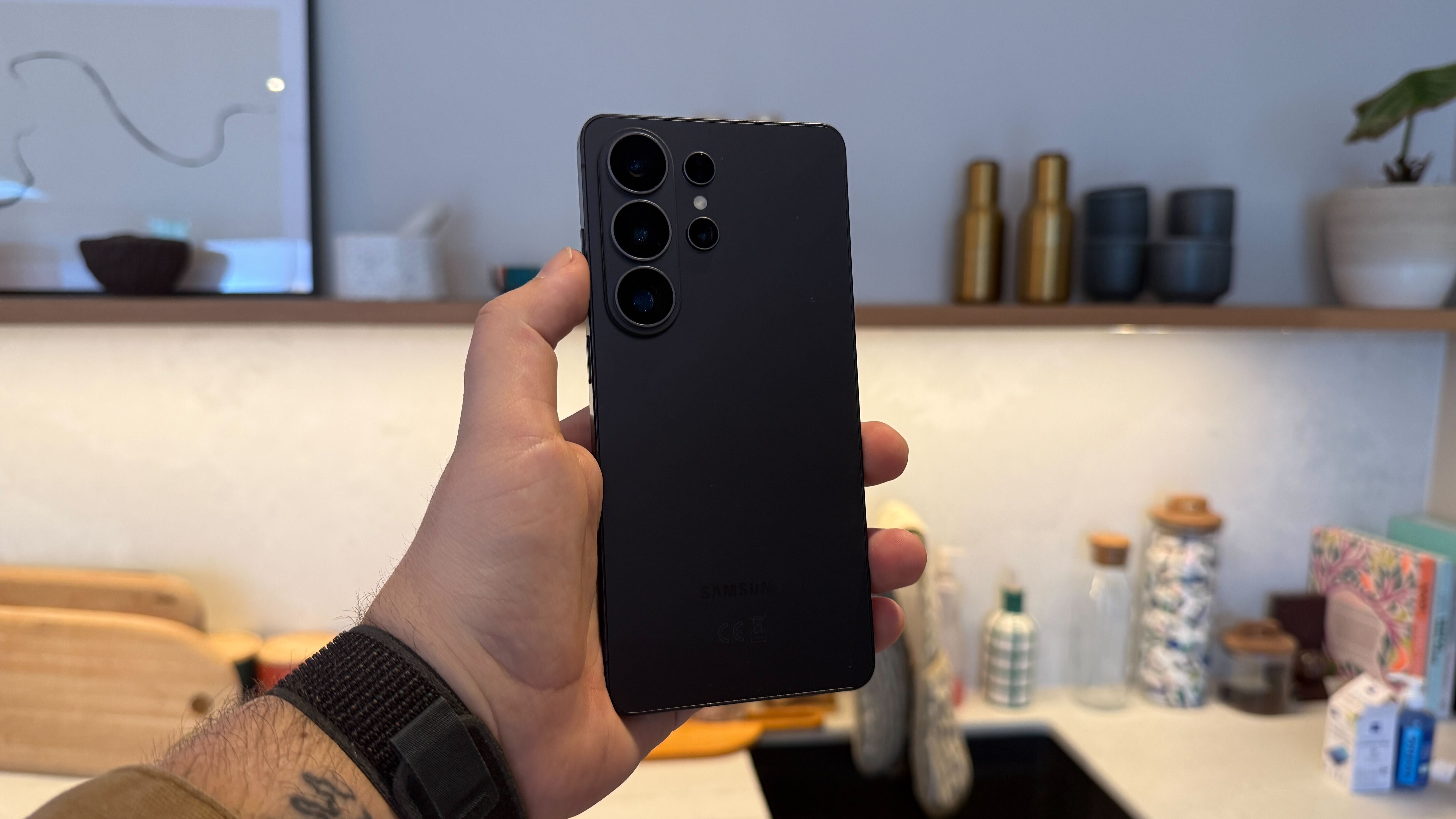 The Samsung Galaxy S26 range being held in a modern living space