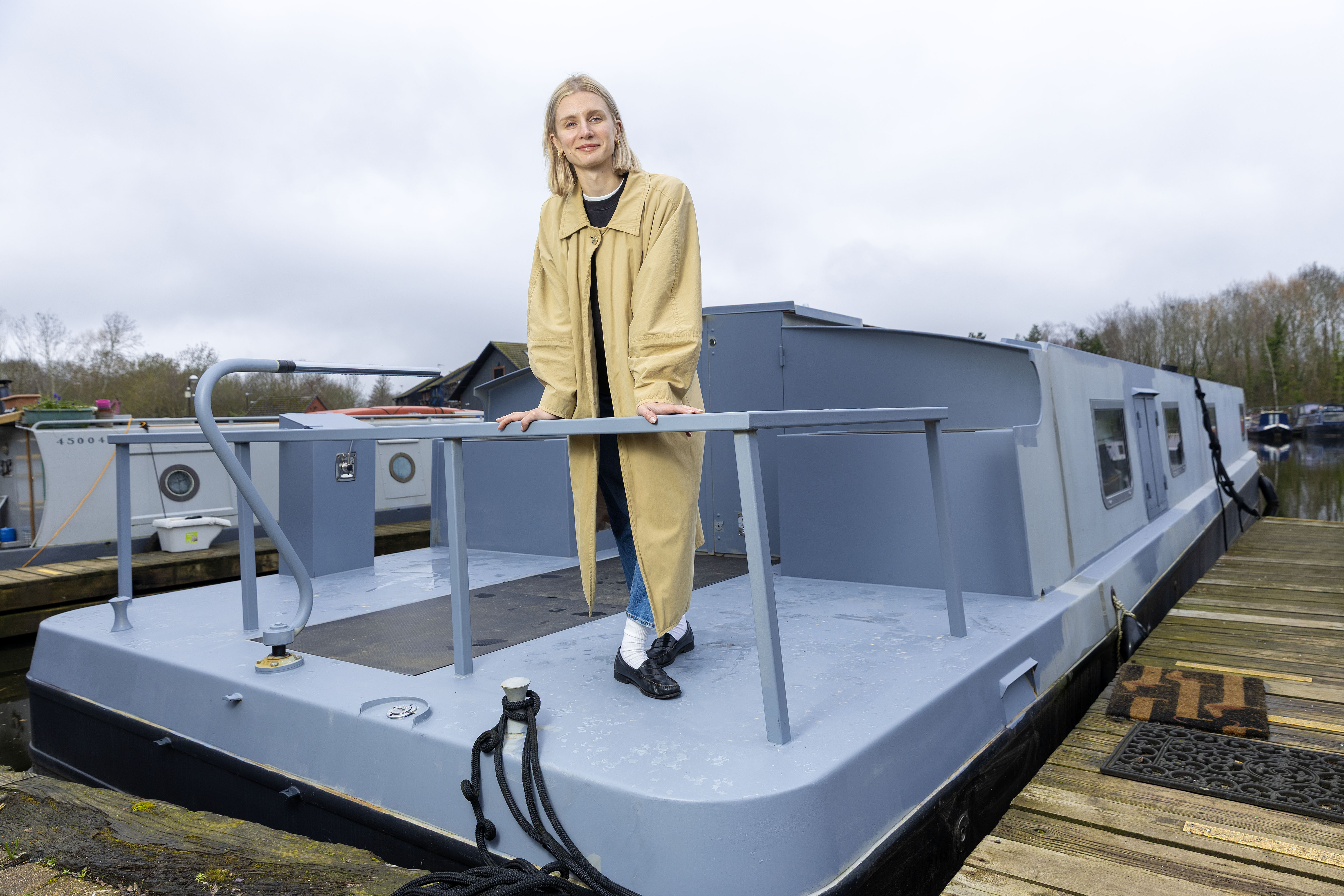 Rosanna Irwin posing with her houseboat in West London.