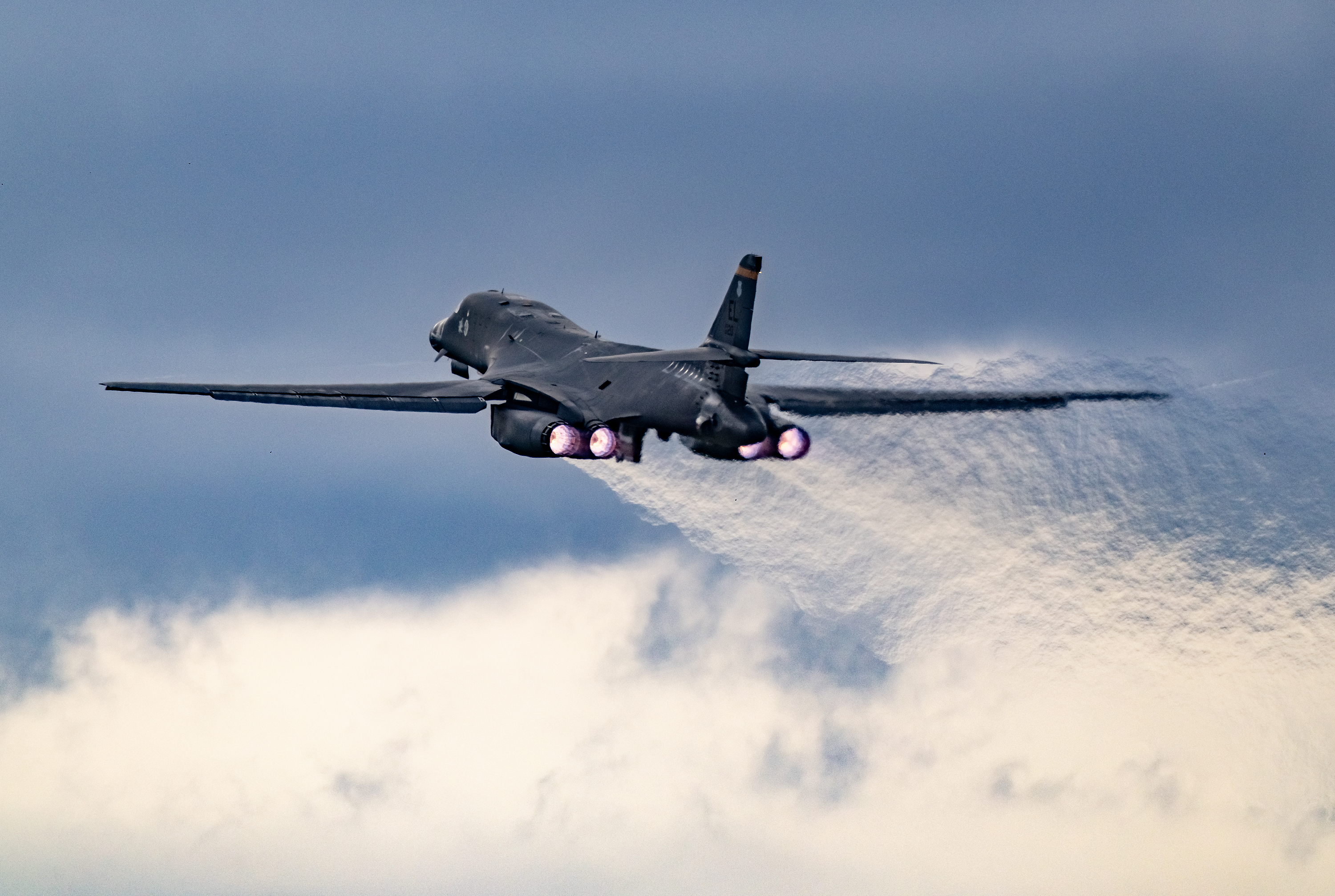 A USAF B1-B bomber takes off from RAF Fairford with afterburners glowing.