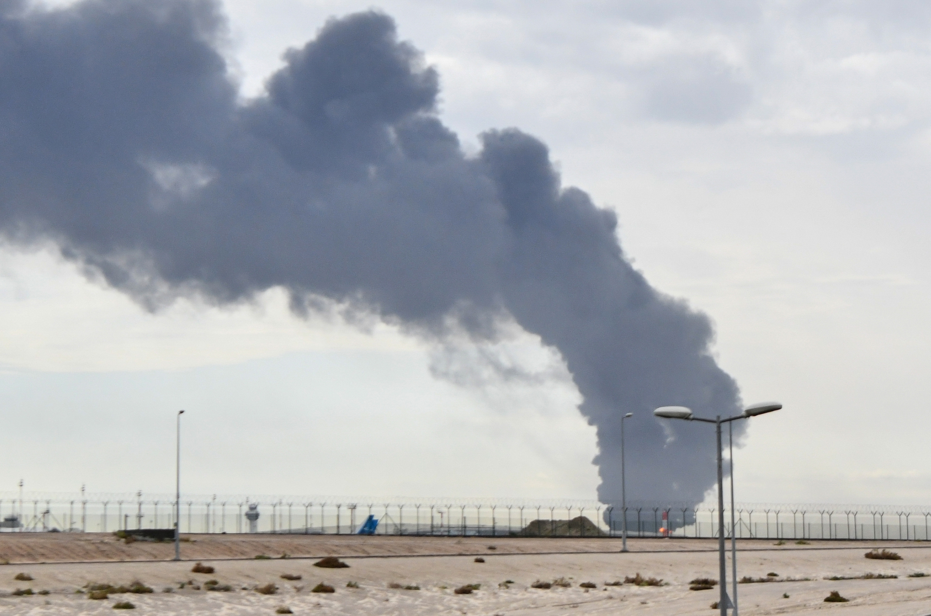 Smoke rises after an attack on a fuel depot at Kuwait International Airport