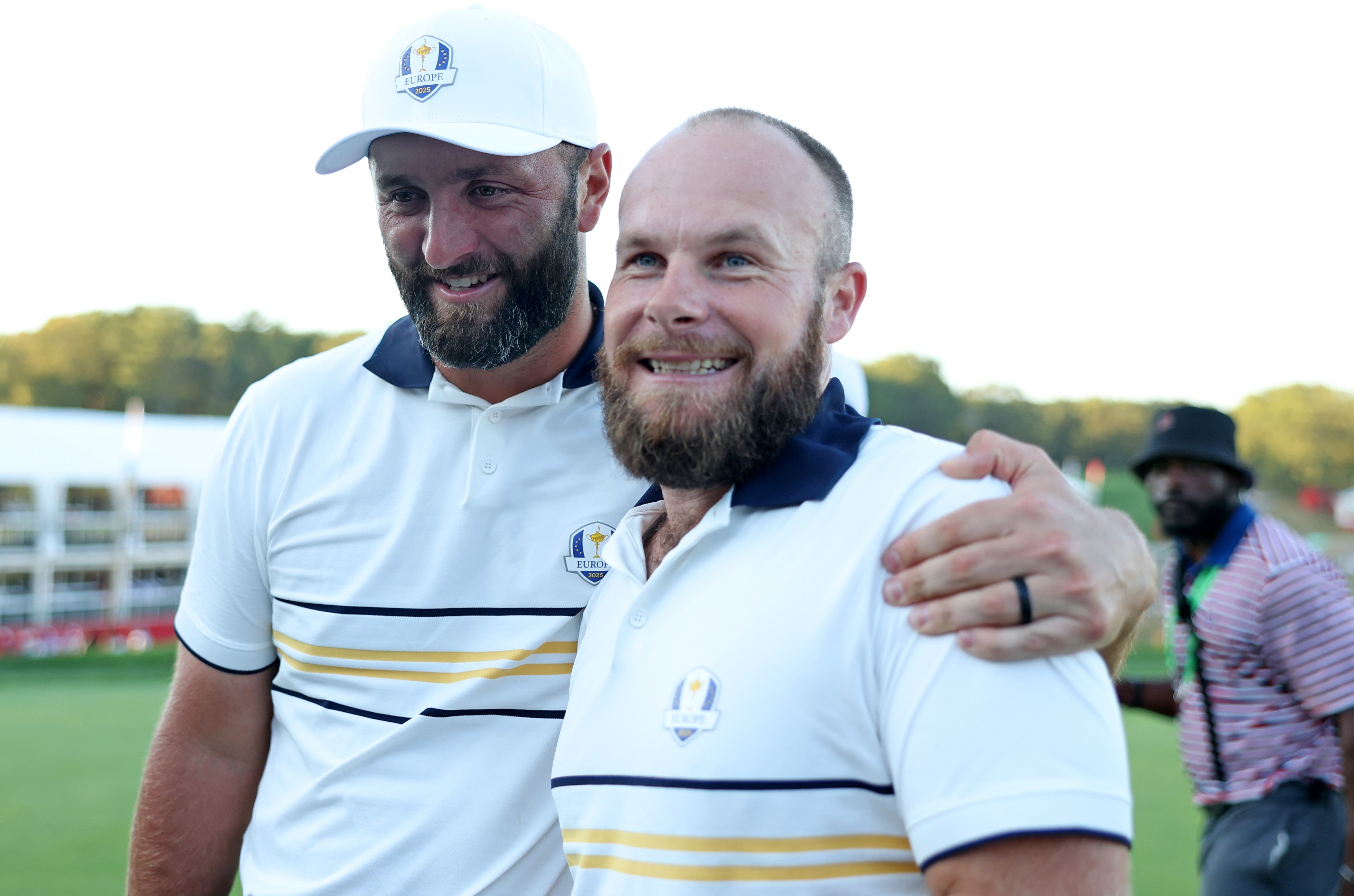 Jon Rahm and Tyrrell Hatton of Team Europe hug during the 2025 Ryder Cup.
