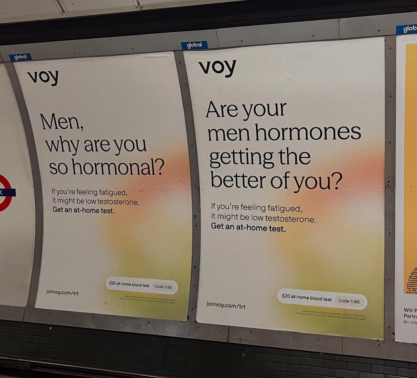 Advertisements for VOY Testosterone tests for men on a subway wall.