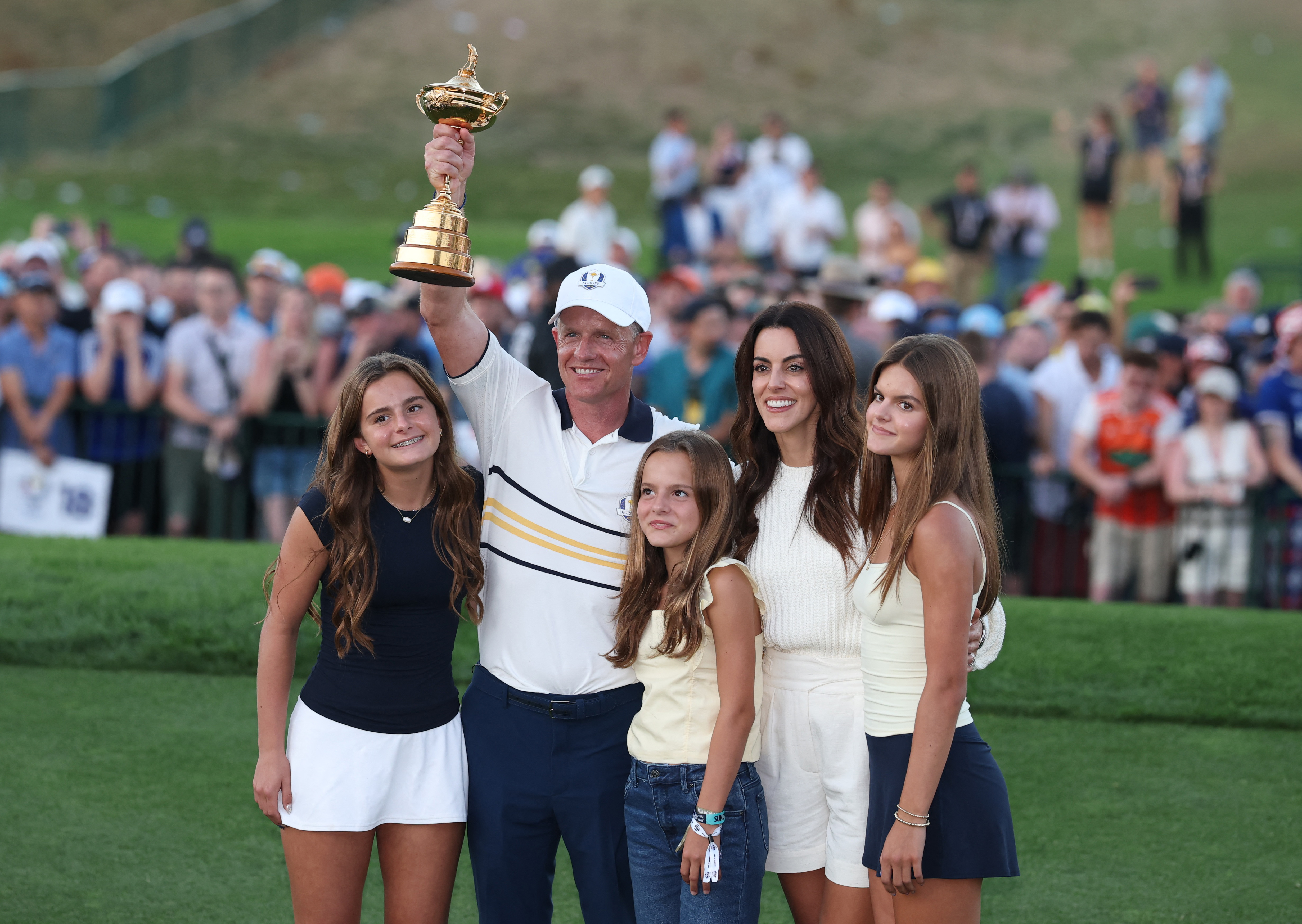 Team Europe captain Luke Donald and his family pose with the Ryder Cup trophy.