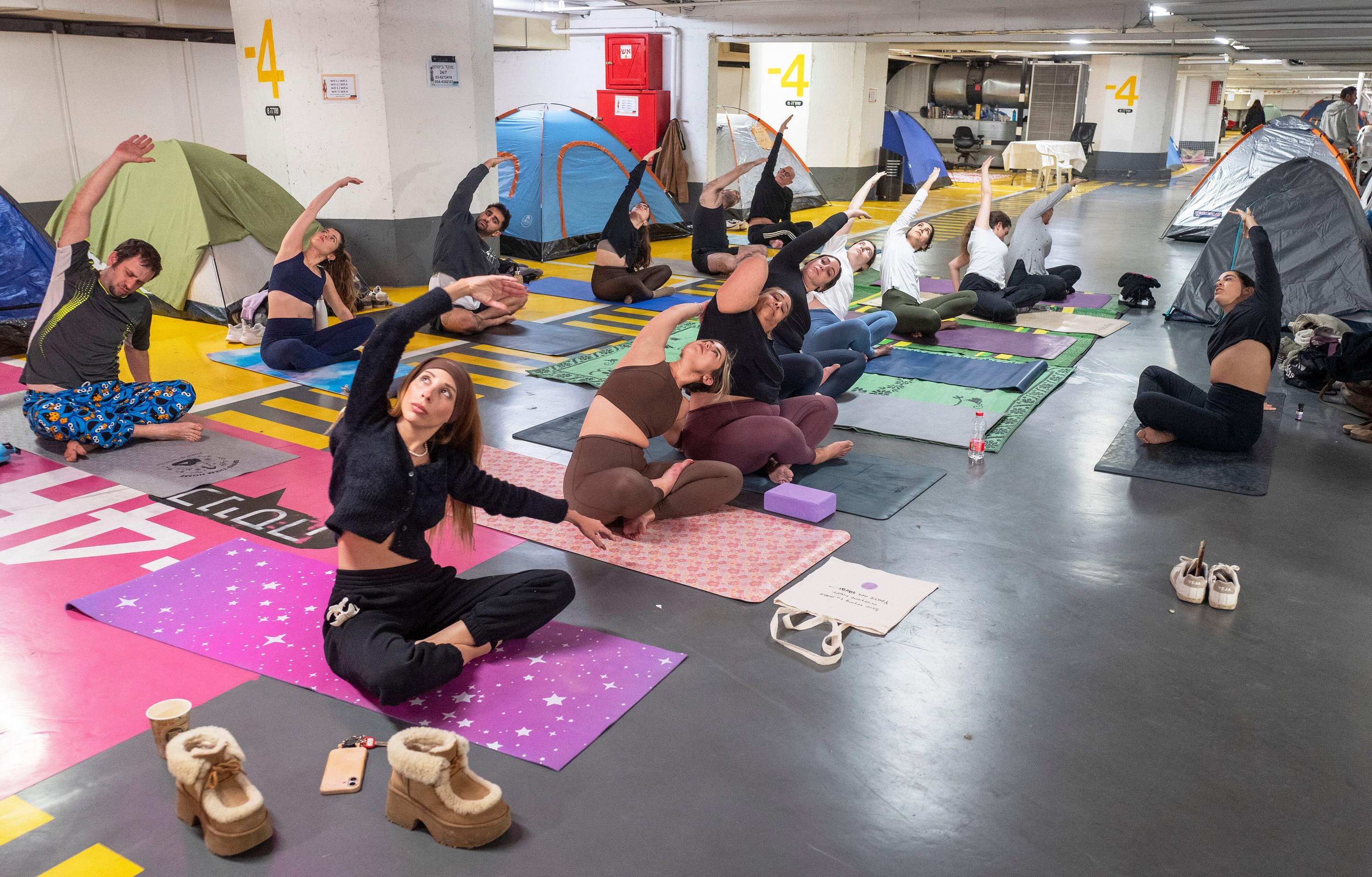 Israelis practise yoga session in a large Tel Aviv underground bomb shelter